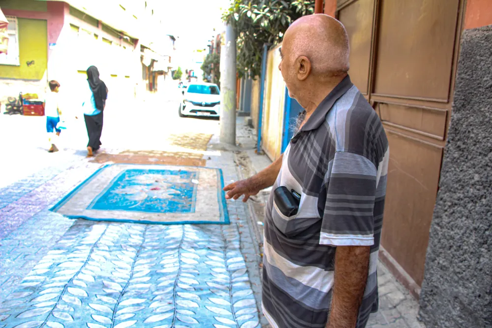  Mahalleli, onarılmayan yollara tozdan korunmak için halı serdi